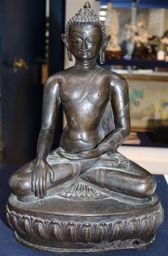 A large Tibetan bronze seated figure of Buddha Shakyamuni, probably 13th century, height 39.5cm, minor old repairs